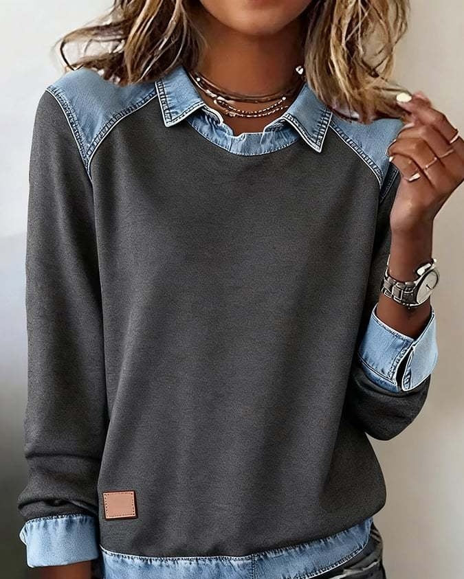 Gray sweatshirt with denim collar and cuffs worn by a person.