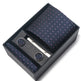 Navy blue tie with pink dots, cufflinks, and a tie clip in a black box on a white background