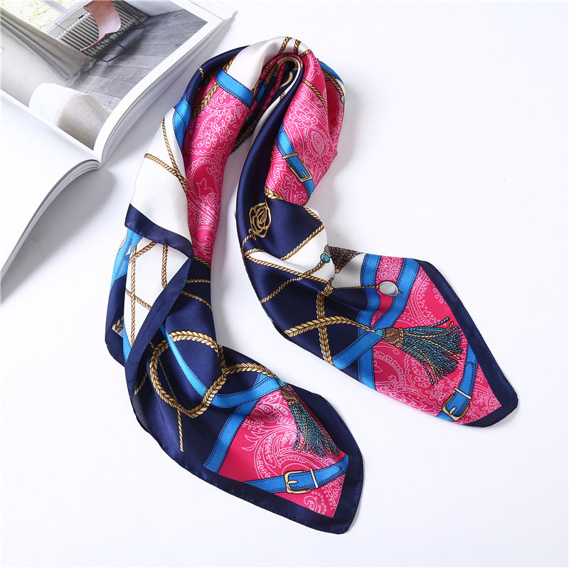 Colorful patterned scarf with a decorative buckle on a white background