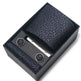 Navy patterned tie set with tie clip and pocket square in a black box on a white background