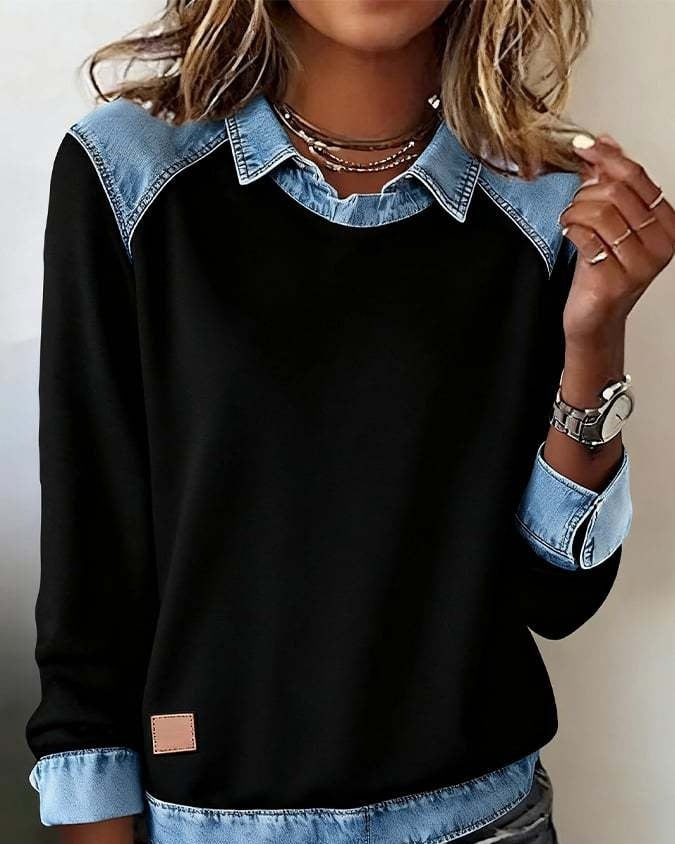 Black sweatshirt with denim collar and cuffs worn by a person.
