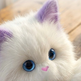 A close-up of a white faux-fur cat plush toy with purple ears, large blue eyes, and a small pink nose, resting on a wooden surface. Text at the top reads 'Baby-grade skin-friendly plush' and 'Petting a cat is an extremely enjoyable experience, a delight for those who are detail-oriented.