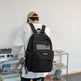 Person wearing a black backpack with 'KOMILD' branding in an indoor setting.