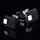 Black and silver square cufflinks on a black background