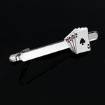 Silver tie clip with playing card design on a black background