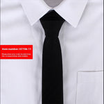 Black tie worn with a white shirt on a light gray background