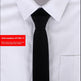 Black tie worn with a white shirt on a light gray background