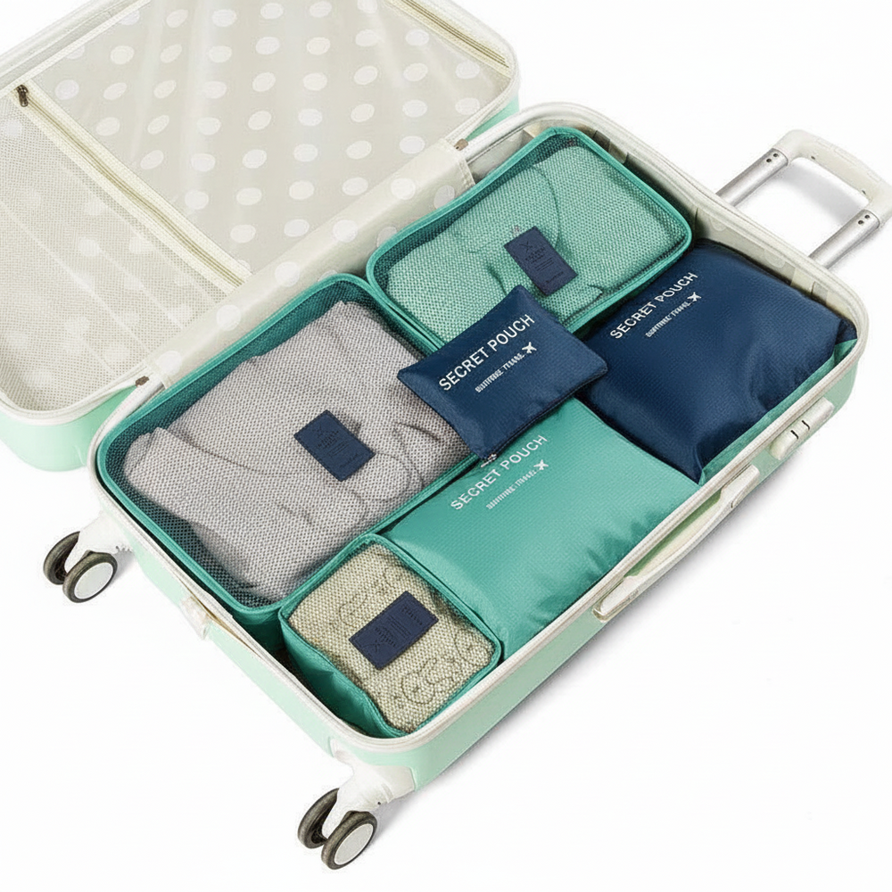 A mint green suitcase opened to show packing cubes and travel organization bags inside. The set includes gray, teal, and navy fabric packing cubes with navy labels reading 'SECRET POUCH' and 'SECRET BAG'.