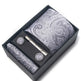 Paisley patterned tie set with tie clip and cufflinks in a black box on a white background
