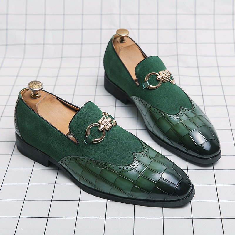 Green loafers with gold buckles on a grid background
