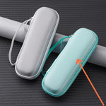 Two cylindrical mesh cases, one gray and one turquoise, on a textured black surface.