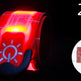 Two red reflective wristbands with a sun symbol on a black background