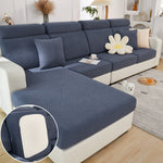 Blue sectional sofa with a close-up of the fabric texture in a living room setting.
