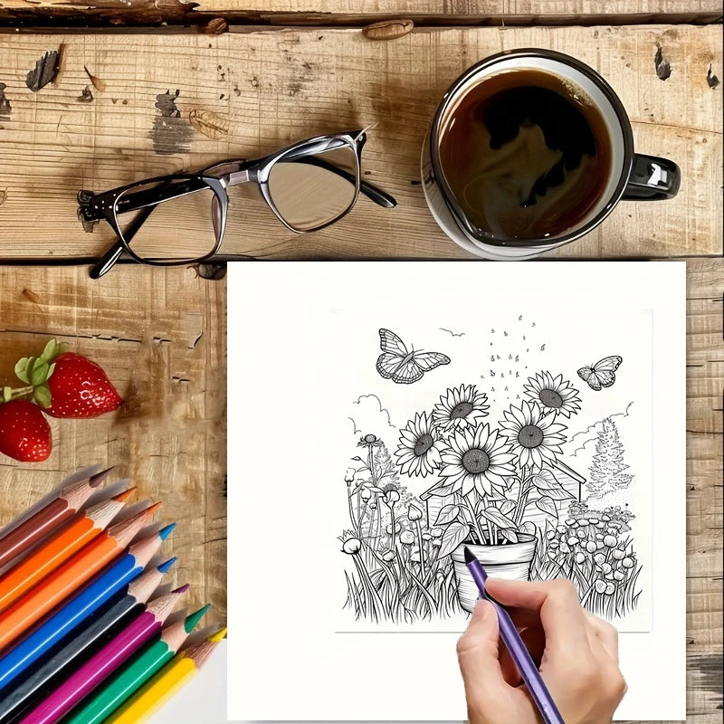 Coloring book with flowers and butterflies, colored pencils, a cup of coffee, and glasses on a wooden surface.