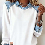 White sweatshirt with denim collar and cuffs worn by a person.
