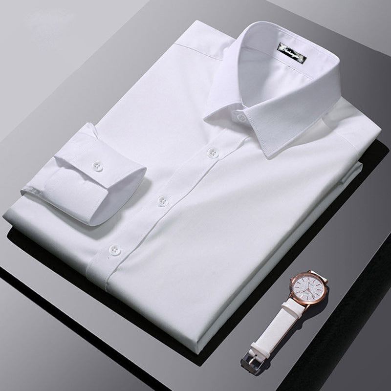 Folded white dress shirt with a white watch on a gray surface