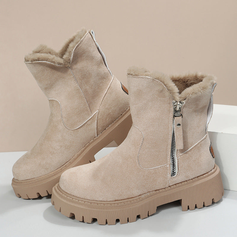 Beige winter boots with fur lining on a light background
