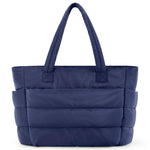 Blue quilted tote bag on a white background