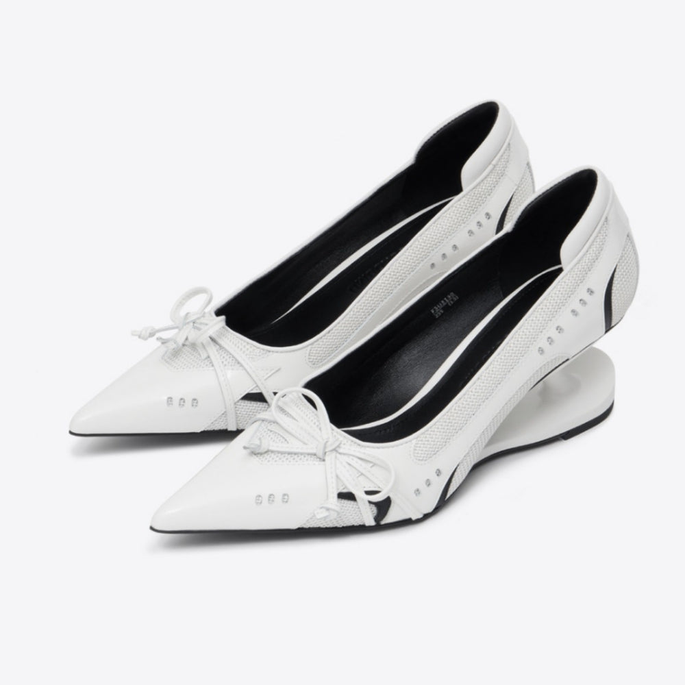 Pair of white pointed-toe shoes with black soles on a white background