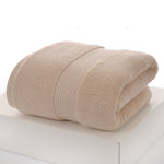 Beige towel folded on a white surface