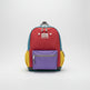 Colorful backpack with purple compartment on a white surface with decorative items.