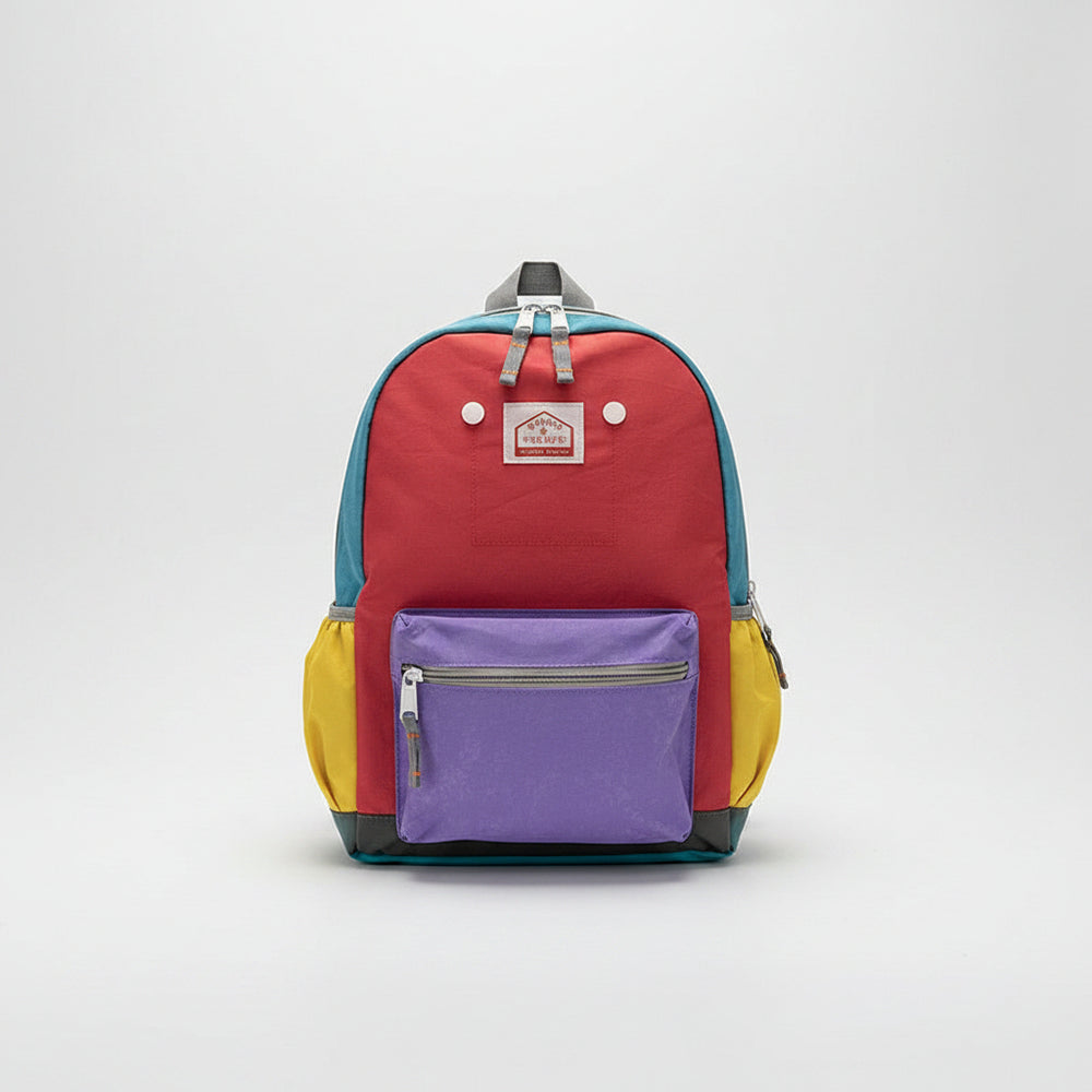 Colorful backpack with purple compartment on a white surface with decorative items.