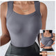 Gray tank top with built-in shelf bra worn by a person, on a light gray background.