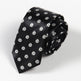 Black tie with geometric pattern on a light gray background