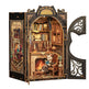 Detailed model of a room with a cat reading a book by a fireplace, featuring intricate design and open door.