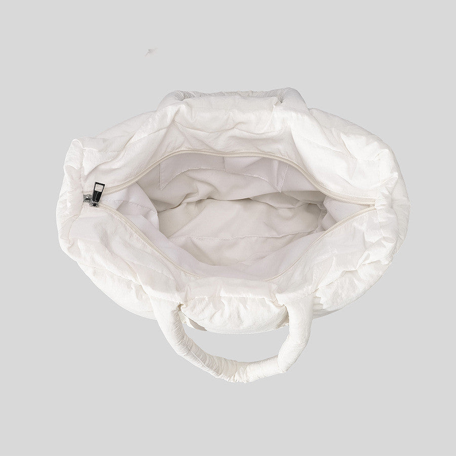 White drawstring bag on a light gray background
