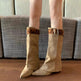 Beige knee-high boots with leopard print straps worn indoors.