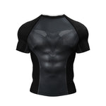A black short-sleeve athletic compression shirt with a textured geometric chevron pattern on the chest, displayed on a clean white background.