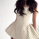 Women's strapless white mini dress with polka dots