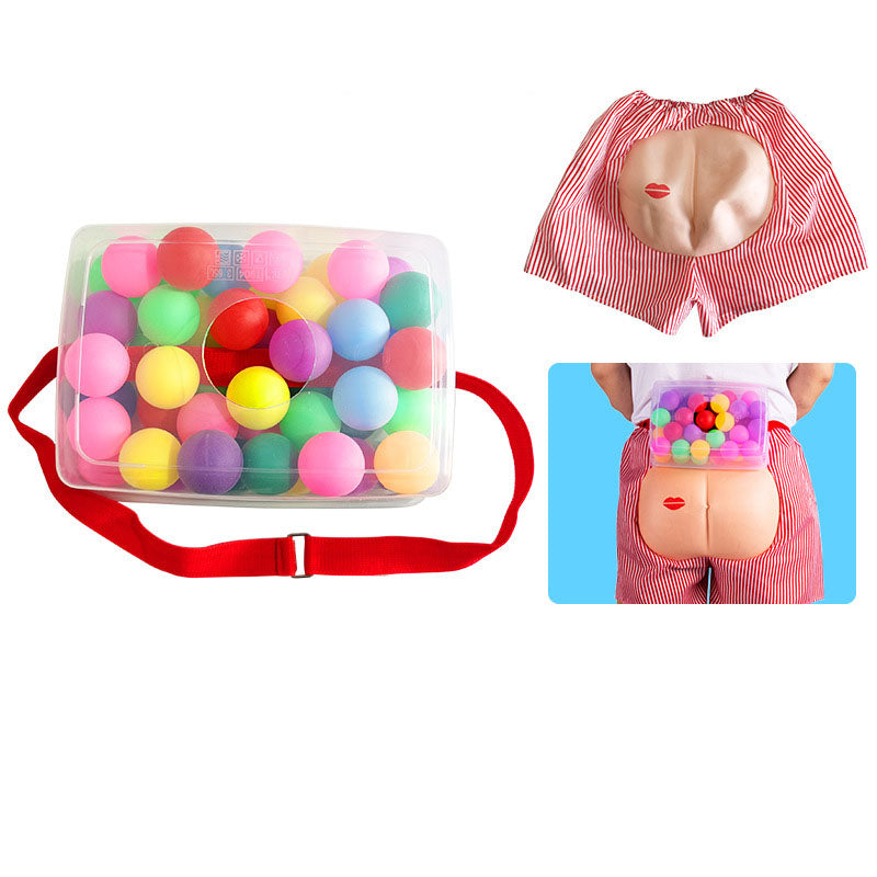 Colorful ball pit with a red bag, anatomical model of a waist, and a person wearing a waist pouch filled with balls.