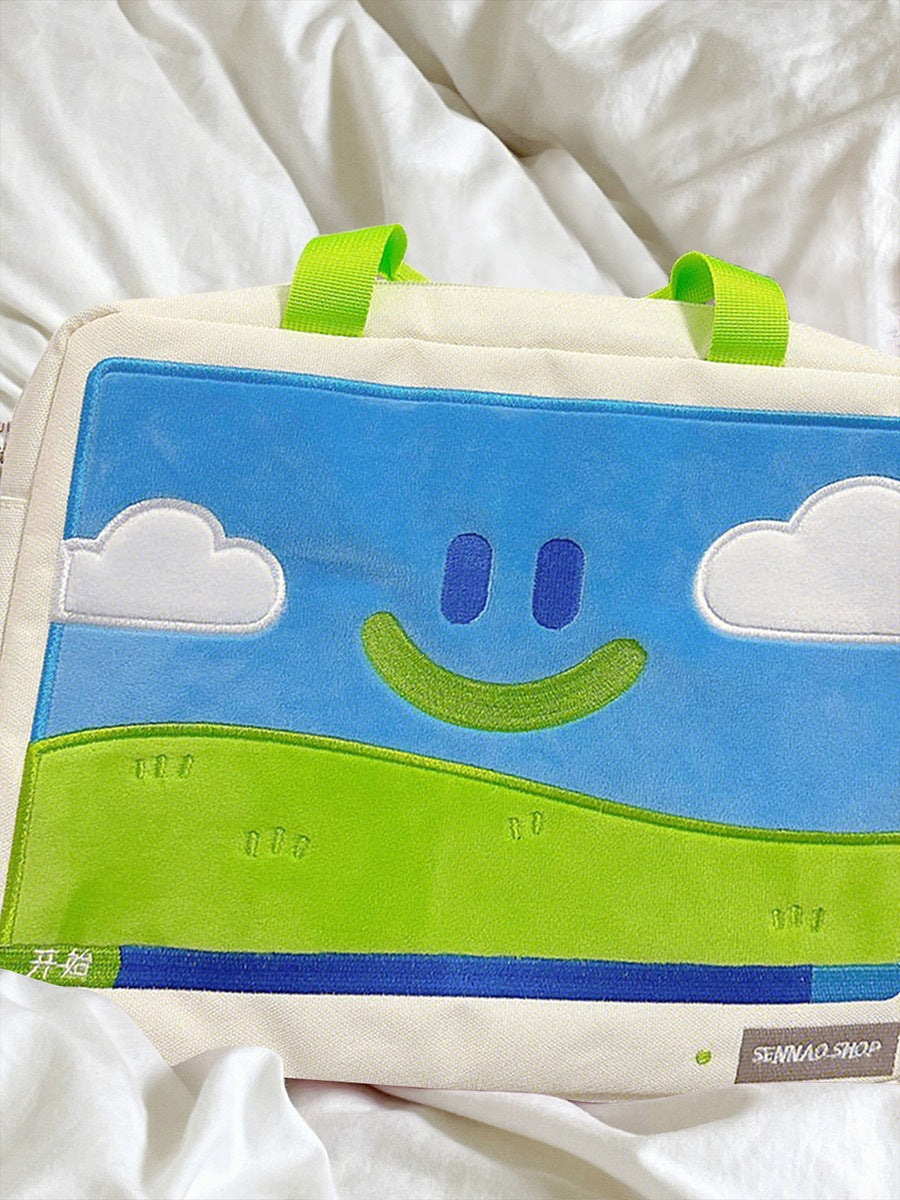 Children's pillow with smiley face design on a white blanket