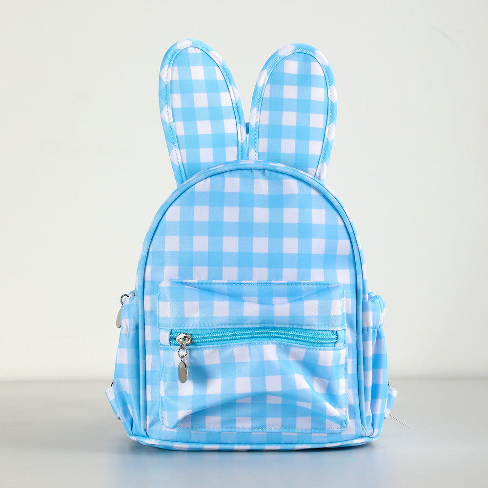 A light blue and white gingham check backpack shaped like a bunny, featuring upright ears and a front zippered pocket, shown against a plain light background.