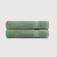 Two folded sage green towels stacked horizontally on a light gray background.