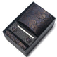 Paisley patterned tie, tie clip, and cufflinks set in a black box.