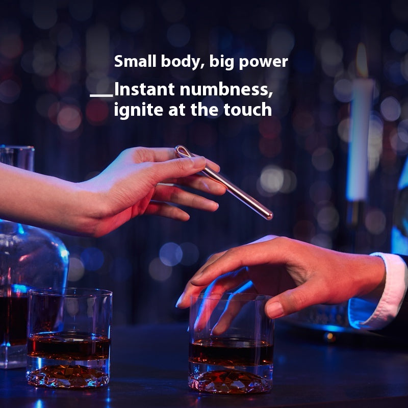 Two hands reaching for a glass of dark liquid with a blurred background