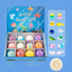 Box of bath bombs with colorful packaging and small bath bombs displayed on a blue background.
