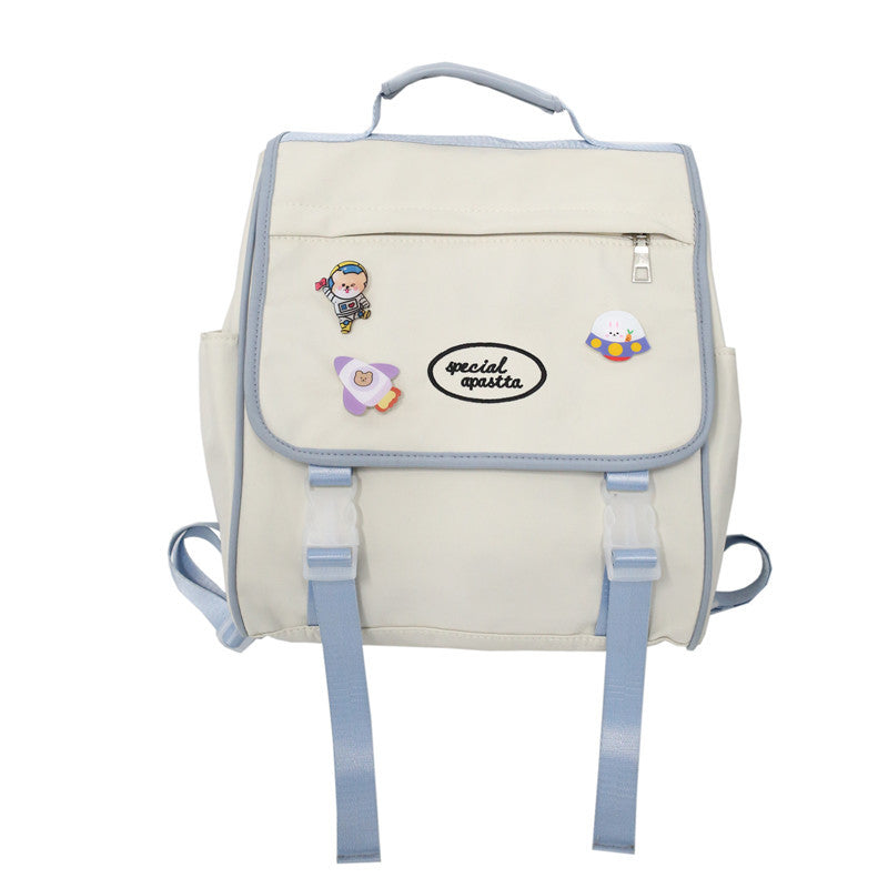 Beige backpack with cartoon character stickers on a white background
