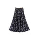 Black floral patterned skirt on a white background
