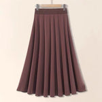 Brown skirt on a hanger against a beige background
