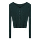 Dark green ribbed sweater with buttons on a white background