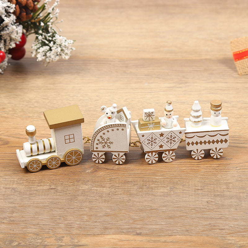 Wooden toy train set on a wooden surface with decorative elements in the background.