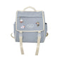 Gray backpack with cartoon character patches on a white background