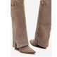 Brown suede boots with decorative studs on a white background