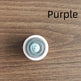 Round purple object with a pattern on a wooden surface