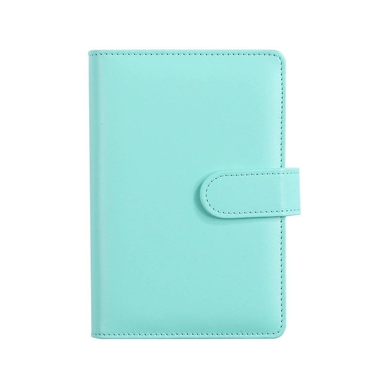 A mint green leather planner cover with a snap-button strap closure, shown flat against a solid white background.