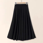 Black skirt on a hanger against a beige background